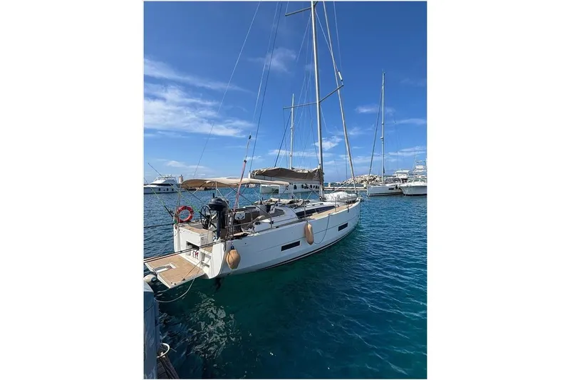  Yacht Photos Pics 2019 Dufour 390 Grand Large sailboat docked in a sunny marina.