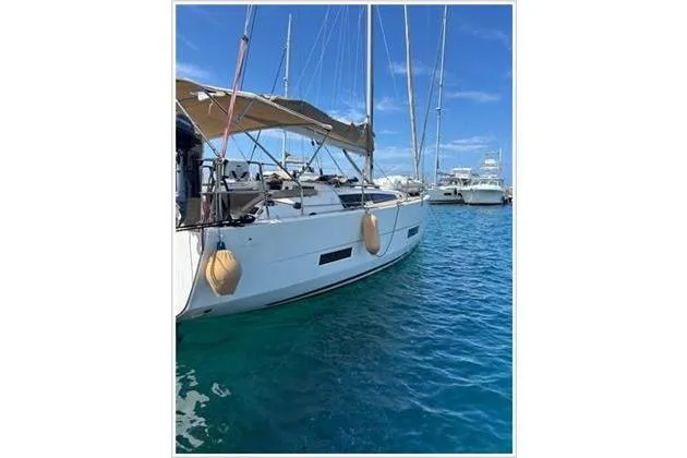  Yacht Photos Pics 2019 Dufour 390 Grand Large sailboat docked in clear blue water.