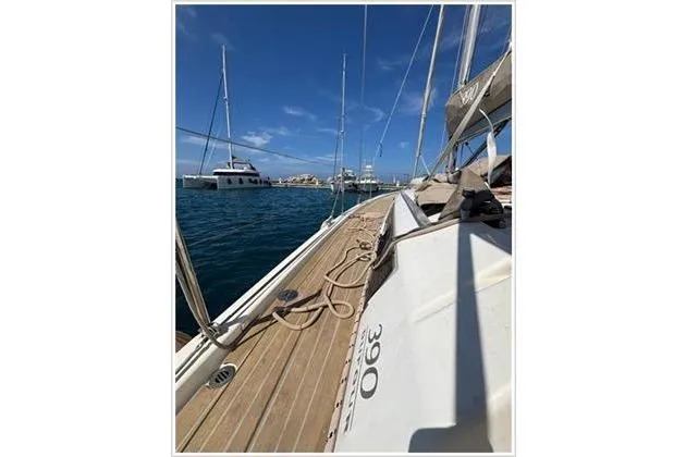 Yacht Photos Pics Sailing yacht Dufour 390 Grand Large 2019 on calm waters, with clear blue sky.