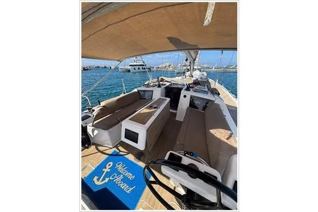  Yacht Photos Pics 2019 Dufour 390 Grand Large yacht with spacious deck and seating, docked in a sunny marina.