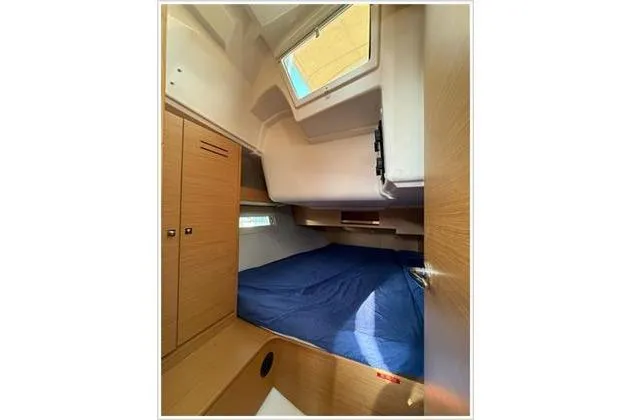  Yacht Photos Pics Cabin interior of 2019 Dufour 390 Grand Large yacht with blue bedding.