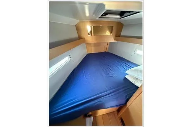  Yacht Photos Pics Cozy cabin interior of 2019 Dufour 390 Grand Large yacht with blue bedding.