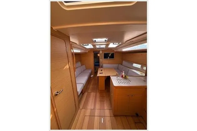  Yacht Photos Pics Interior of 2019 Dufour 390 Grand Large yacht with modern wood finish and seating area.