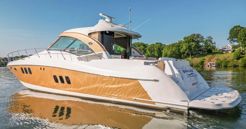  Yacht Photos Pics 2006 Sea Ray 60 Sundancer yacht on calm water, showcasing sleek design and luxury features.