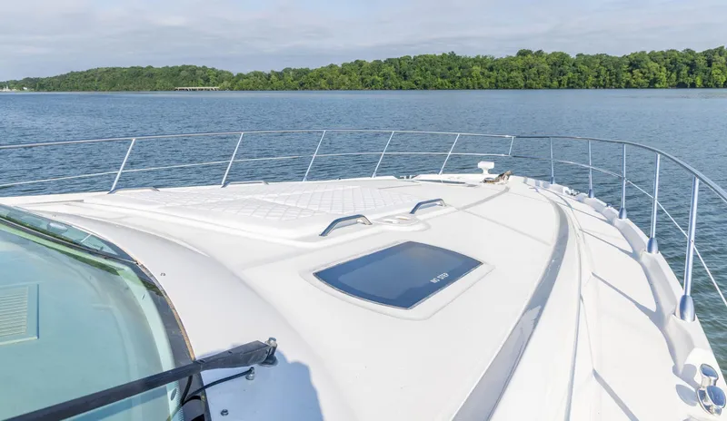  Yacht Photos Pics 2006 Sea Ray 60 Sundancer yacht on calm water, featuring sleek deck design.