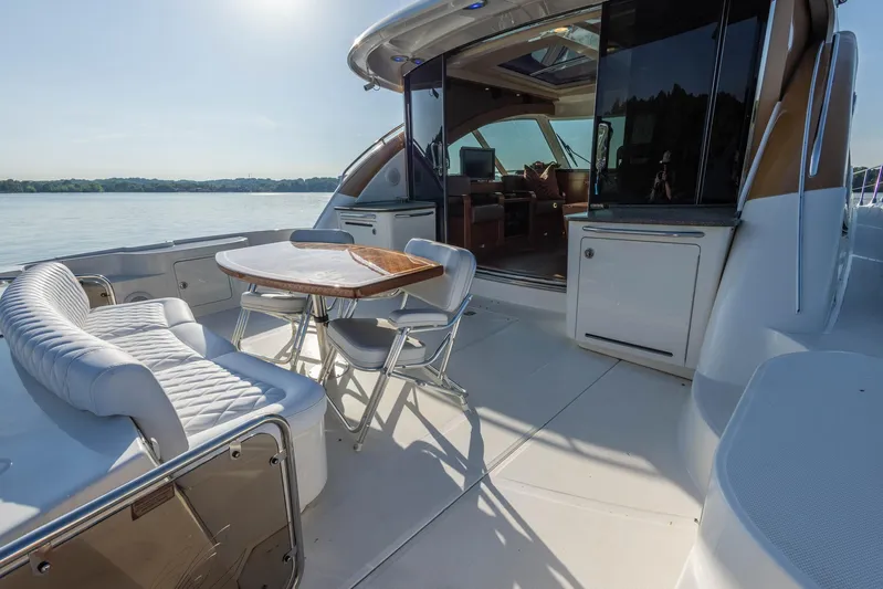  Yacht Photos Pics Luxurious 2006 Sea Ray 60 Sundancer yacht with elegant outdoor seating and dining area.