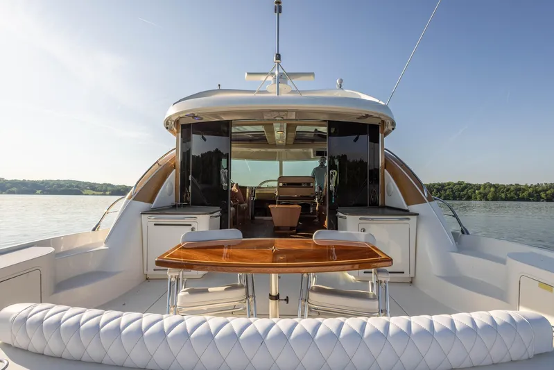  Yacht Photos Pics 2006 Sea Ray 60 Sundancer yacht with elegant outdoor seating and dining area.