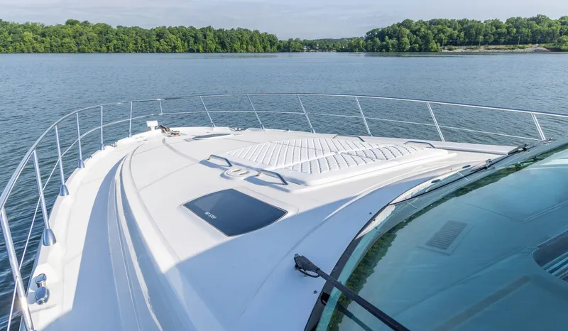  Yacht Photos Pics 2006 Sea Ray 60 Sundancer yacht on calm water, showcasing sleek deck design.