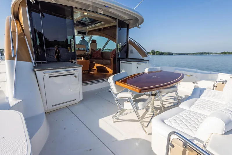  Yacht Photos Pics 2006 Sea Ray 60 Sundancer yacht with outdoor seating and table on deck.