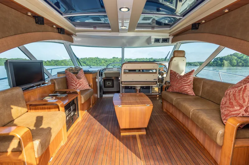  Yacht Photos Pics Luxurious interior of 2006 Sea Ray 60 Sundancer yacht with elegant wood finishes and plush seating.