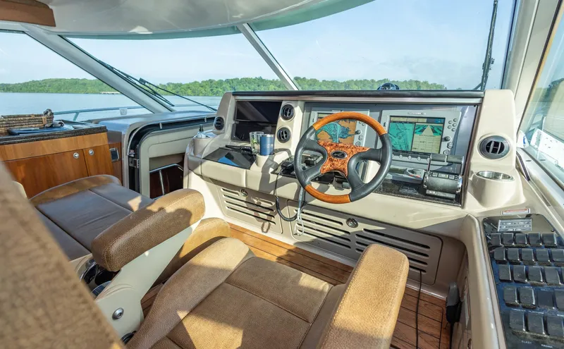  Yacht Photos Pics Helm of 2006 Sea Ray 60 Sundancer yacht with navigation equipment and wooden steering wheel.