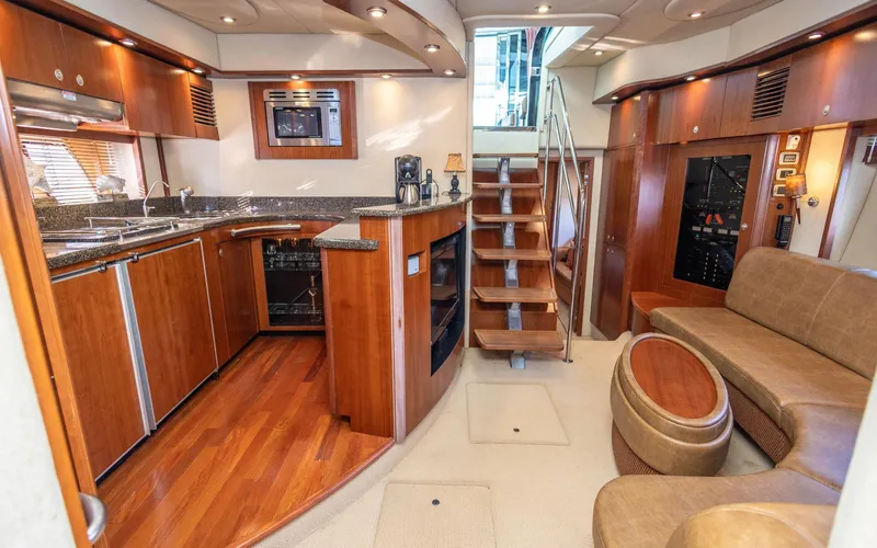  Yacht Photos Pics Luxurious interior of 2006 Sea Ray 60 Sundancer yacht with kitchen and seating area.