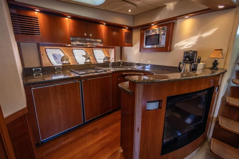  Yacht Photos Pics Luxurious kitchen interior of 2006 Sea Ray 60 Sundancer yacht with modern amenities.