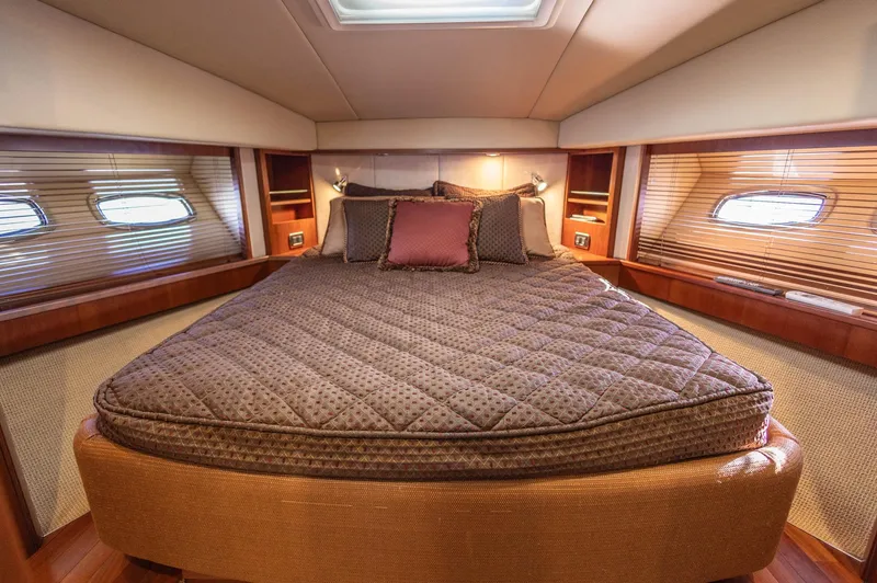  Yacht Photos Pics Luxurious bedroom interior of 2006 Sea Ray 60 Sundancer yacht with plush bedding.