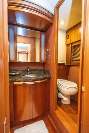  Yacht Photos Pics Luxurious bathroom in 2006 Sea Ray 60 Sundancer yacht with wood accents and modern fixtures.