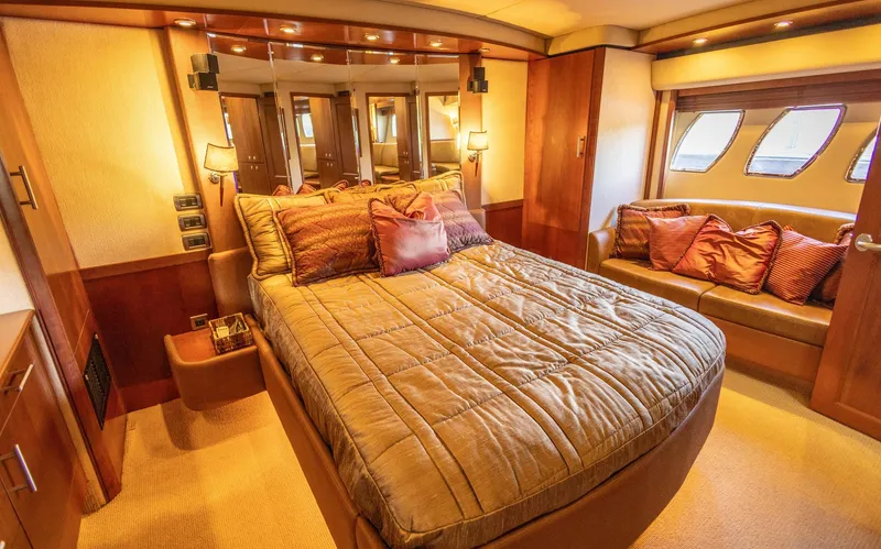  Yacht Photos Pics Luxurious bedroom interior of 2006 Sea Ray 60 Sundancer yacht with cozy bedding and elegant decor.