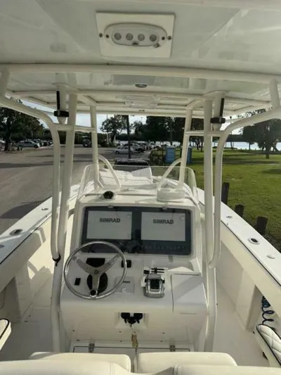 No Name Yacht Photos Pics 2008 Jupiter 31 FS Center Console boat with dual Simrad displays, docked near a park.