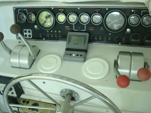  Yacht Photos Pics 1988 Chris-Craft Constellation boat dashboard with gauges, controls, and steering wheel.