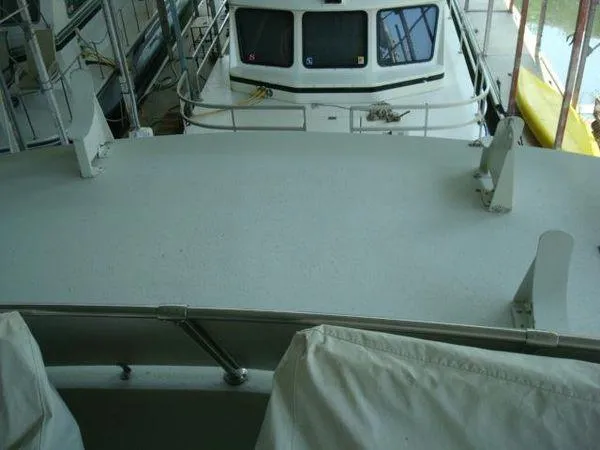  Yacht Photos Pics 1988 Chris-Craft Constellation boat deck with railing and covered seating.