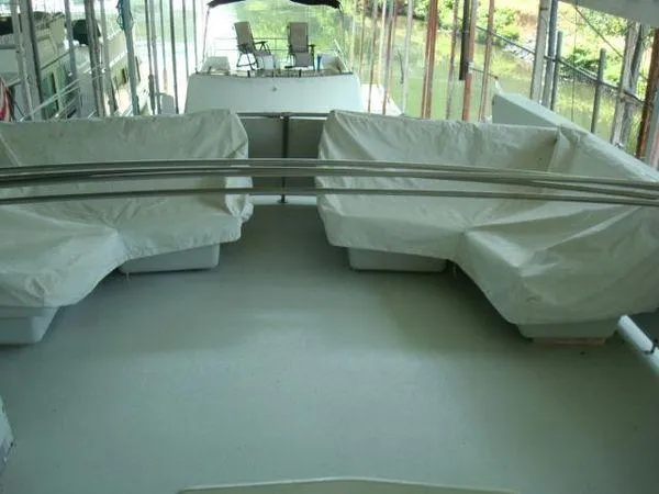  Yacht Photos Pics 1988 Chris-Craft Constellation boat deck with covered seating and scenic water view.