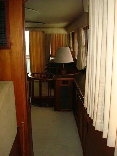  Yacht Photos Pics Interior of 1988 Chris-Craft Constellation yacht with wood paneling and curtains.