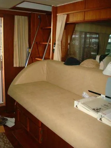  Yacht Photos Pics 1988 Chris-Craft Constellation interior with beige seating and wooden accents.