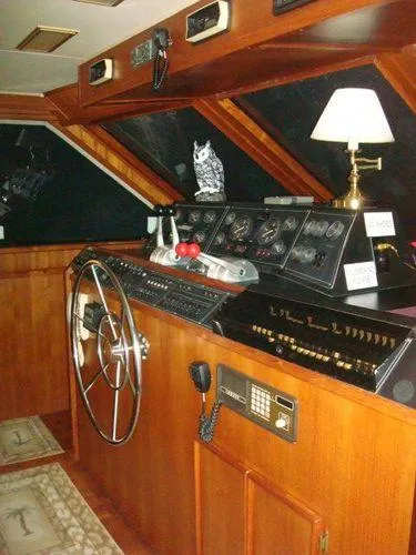  Yacht Photos Pics 1988 Chris-Craft Constellation yacht helm with wooden interior and vintage controls.