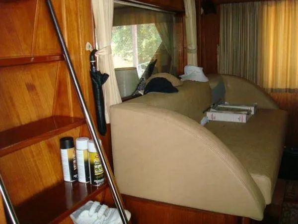  Yacht Photos Pics 1988 Chris-Craft Constellation interior with wooden shelves and beige seating.