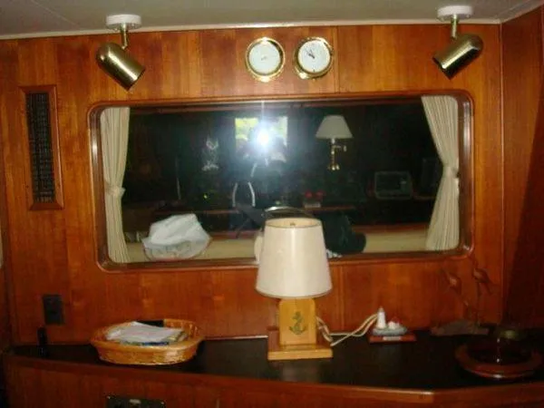  Yacht Photos Pics 1988 Chris-Craft Constellation yacht interior with wood paneling, window, and nautical decor.