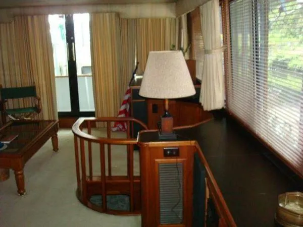  Yacht Photos Pics Interior of 1988 Chris-Craft Constellation yacht with wooden furnishings and large windows.