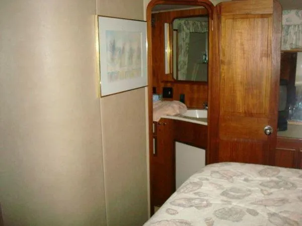  Yacht Photos Pics Interior of 1988 Chris-Craft Constellation yacht with wood paneling and cozy decor.