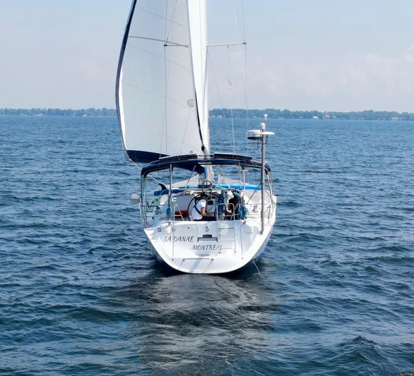 Danae Yacht Photos Pics Beneteau Oceanis Clipper 393 sailboat on open water, 2003 model, rear view.