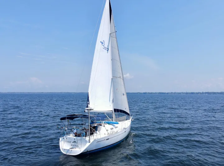 Danae Yacht Photos Pics 2003 Beneteau Oceanis Clipper 393 sailing on open water under clear blue skies.