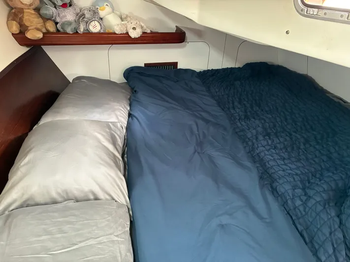 Danae Yacht Photos Pics Cozy cabin bed with plush toys on a 2003 Beneteau Oceanis Clipper 393 yacht.
