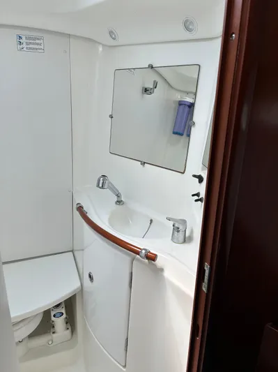 Danae Yacht Photos Pics Bathroom interior of 2003 Beneteau Oceanis Clipper 393 yacht, featuring sink and mirror.
