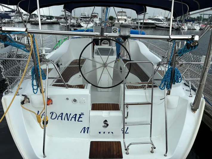 Danae Yacht Photos Pics 2003 Beneteau Oceanis Clipper 393 sailboat docked at marina, featuring spacious cockpit and steering wheel.