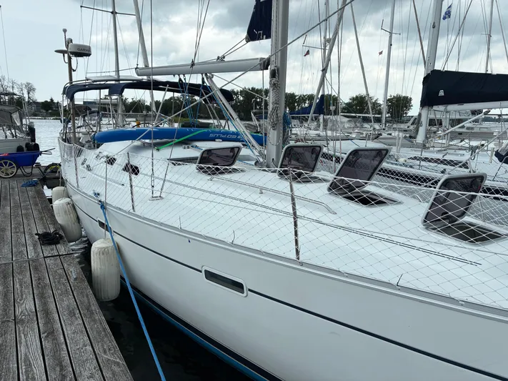 Danae Yacht Photos Pics 2003 Beneteau Oceanis Clipper 393 sailboat docked at marina, overcast sky.