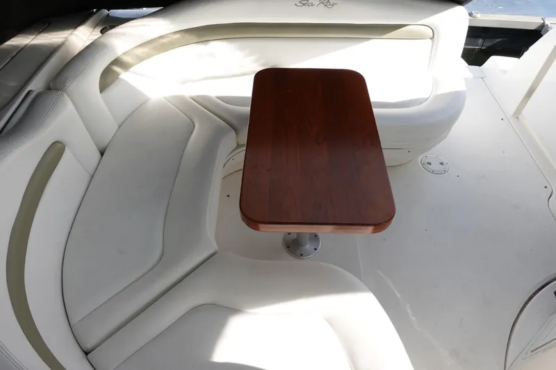  Yacht Photos Pics 2007 Sea Ray 320 Sundancer interior with white seating and wooden table.