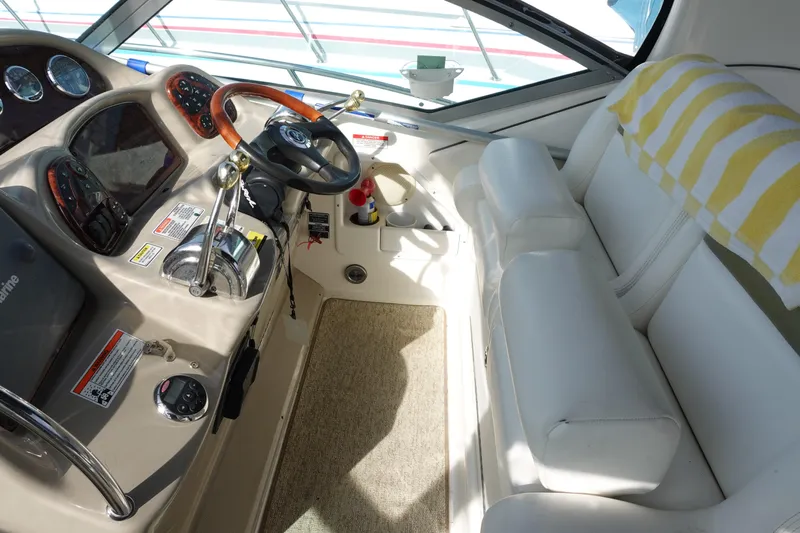  Yacht Photos Pics 2007 Sea Ray 320 Sundancer cockpit with steering wheel, controls, and white seating.