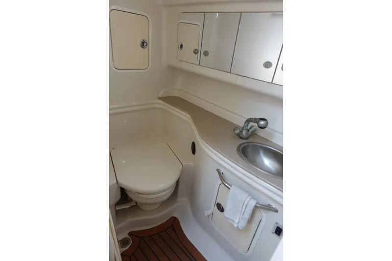  Yacht Photos Pics 2007 Sea Ray 320 Sundancer bathroom with sink, toilet, and storage cabinets.