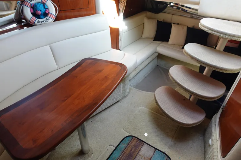  Yacht Photos Pics Interior of 2007 Sea Ray 320 Sundancer with cozy seating and wooden table.