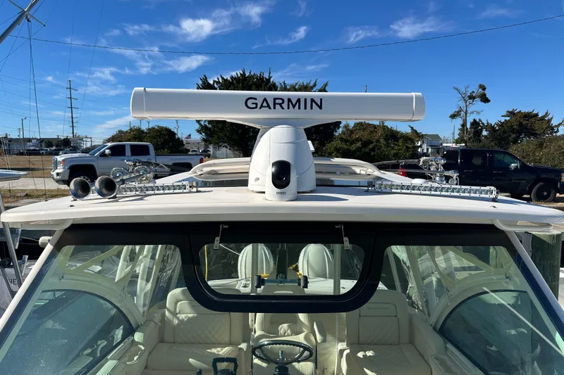  Yacht Photos Pics 2024 Grady-White Express 330 boat with Garmin radar, parked outdoors under clear sky.