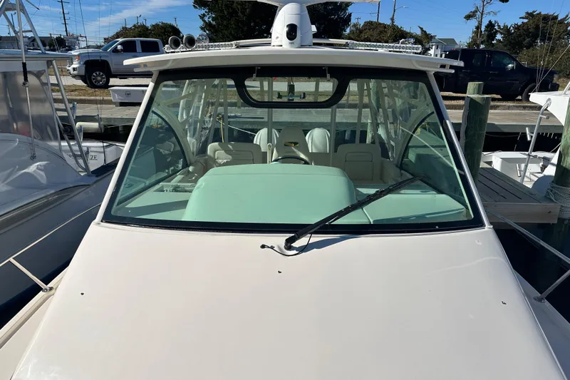  Yacht Photos Pics 2024 Grady-White Express 330 boat docked, front view with windshield and wiper.