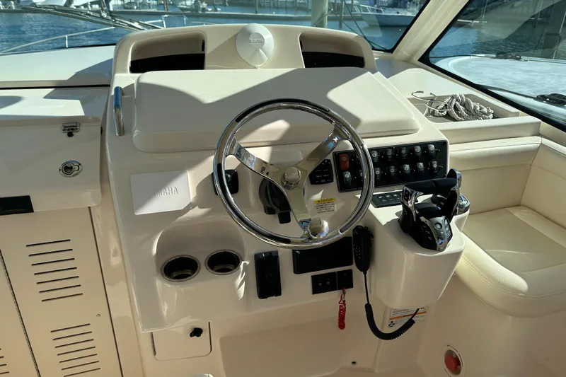  Yacht Photos Pics 2024 Grady-White Express 330 helm with steering wheel and control panel.