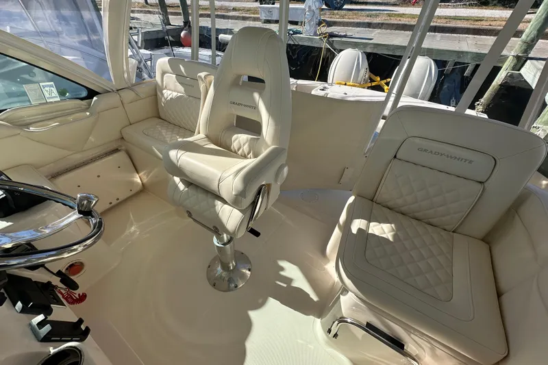  Yacht Photos Pics 2024 Grady-White Express 330 boat interior with luxurious seating and helm.