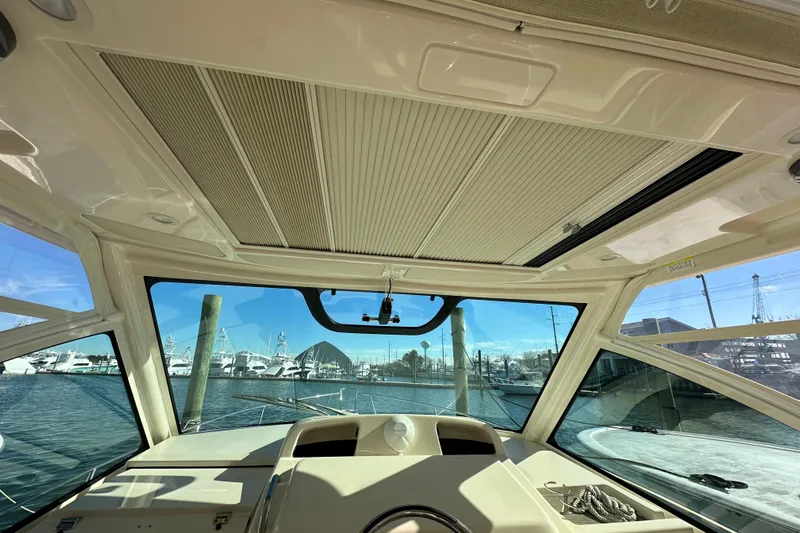  Yacht Photos Pics Interior view of 2024 Grady-White Express 330 boat with marina backdrop.