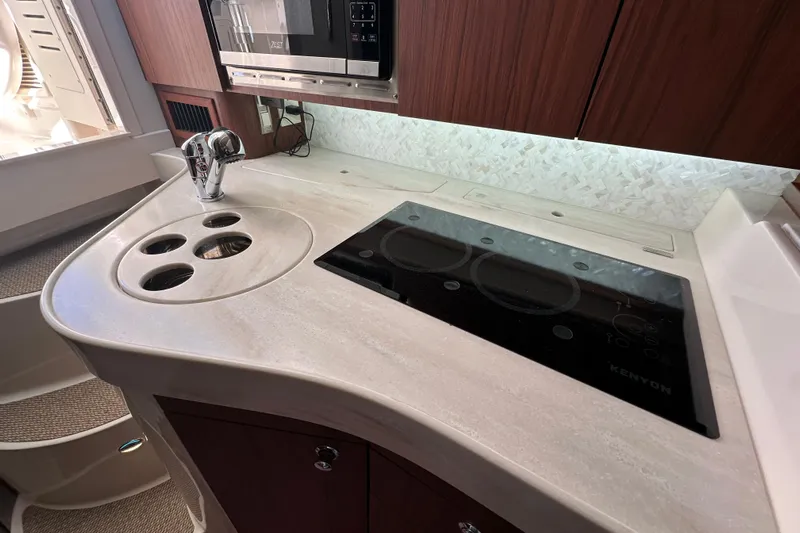  Yacht Photos Pics 2024 Grady-White Express 330 boat kitchen with modern appliances and sleek countertop design.