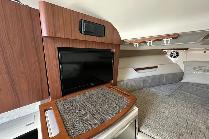  Yacht Photos Pics 2024 Grady-White Express 330 cabin interior with TV and comfortable seating.