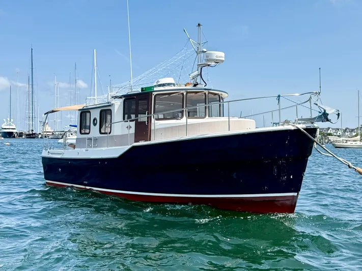 Sam Mcgee Yacht Photos Pics 2009 Ranger Tugs R-29 boat on water, clear sky, marina background.