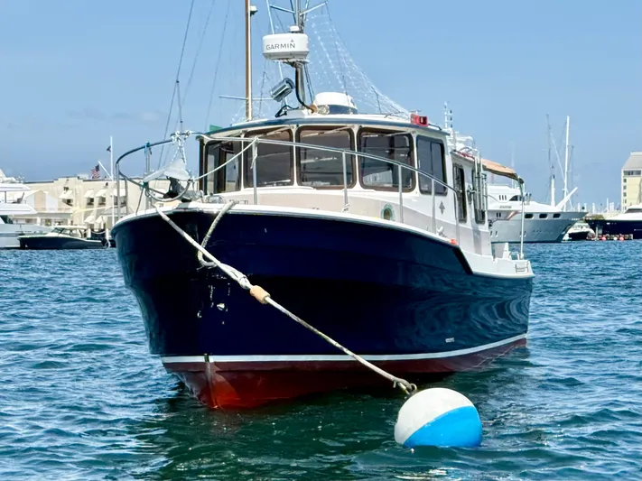 Sam Mcgee Yacht Photos Pics 2009 Ranger Tugs R-29 boat moored in a marina, clear blue sky background.